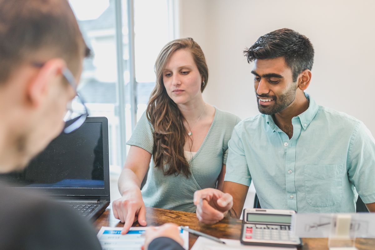 An advisor walking two clients through plan documents
