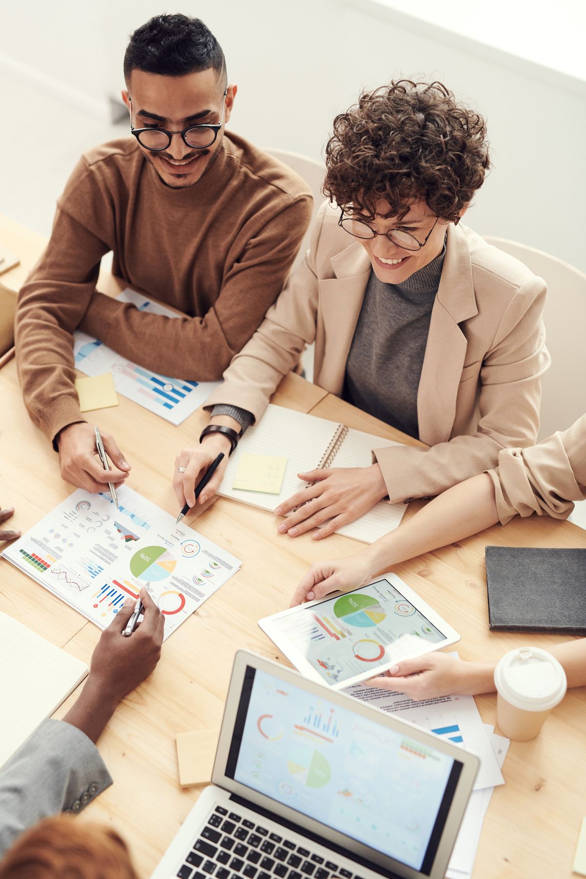 Two professionals reviewing benefit reports at a conference table